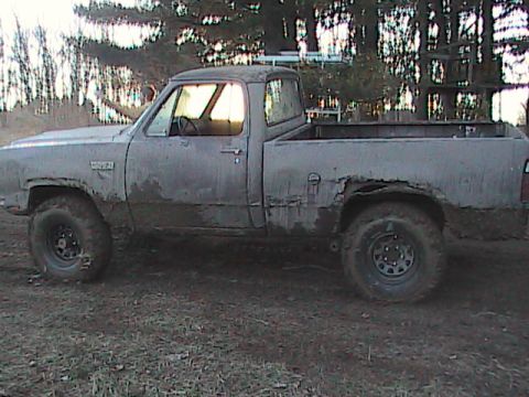 1980 Dodge Magnum - This 1980 Dodge Magnum pickup truck is covered in mud, showing significant rust on the rear fender.