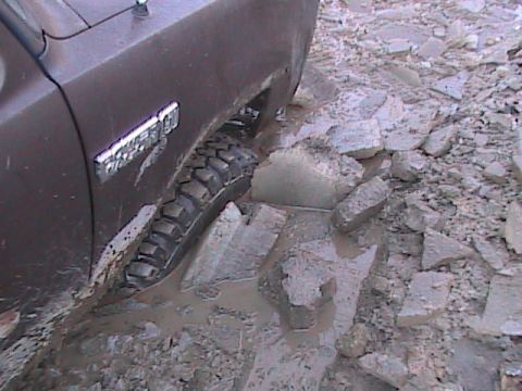 1980 Dodge Magnum - Dodge Ramcharger stuck in mud and rocks, showing side fender and tire.