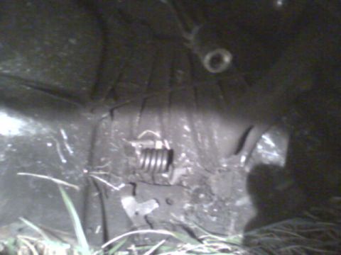 1985 Ford Bronco - A close-up view of a clutch spring and associated linkage, likely from a vehicle's drivetrain.