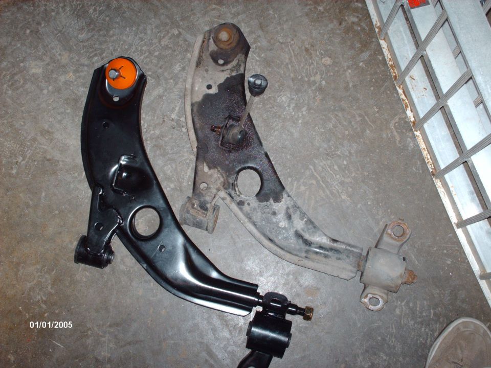 New black control arm next to old rusty one