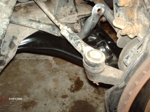 1995 Ford Probe - Close-up view of a vehicle's suspension system, showing various mechanical components.