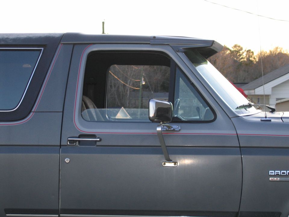 Side view of a gray 1989 Ford Bronco with a visor