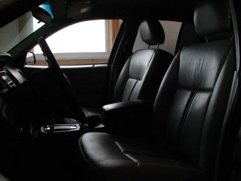 2003 Ford Crown Victoria - Interior view of a vehicle showing the front seats, dashboard, and center console.