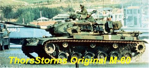 1998 Ford Crown Victoria - A military tank with camouflage paint is shown from the side, with two soldiers visible on its turret.