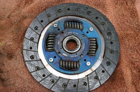 1985 Ford Bronco - A close-up view of a vehicle clutch disc, showing its internal springs and manufacturing details.