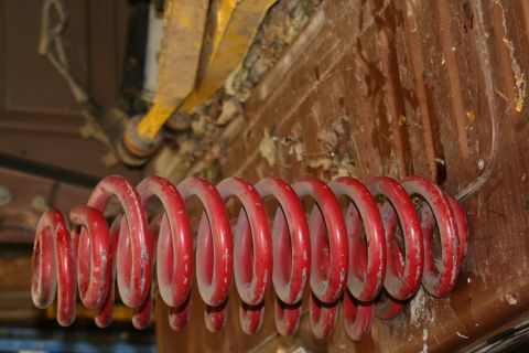 1989 Ford Bronco - A red coil spring is visible on the underside of a vehicle.