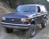 1989 Ford Bronco - This 1989 Ford Bronco is shown from the front three-quarter view on a dirt road.