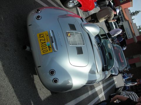 1998 Ford Crown Victoria - silver Porsche 356-style coupe with a yellow California plate, photographed from a low rear-quarter angle at a show.
