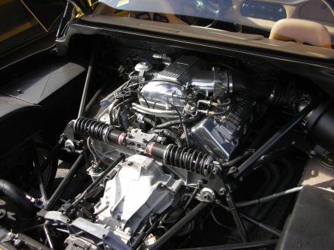 1998 Ford Crown Victoria - mid-mounted polished V engine with tubular frame and coilover suspension in an open engine bay.