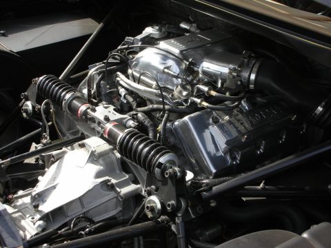1998 Ford Crown Victoria - Detailed close-up of a mid-mounted engine, transaxle and coilover suspension inside a tubular chassis.