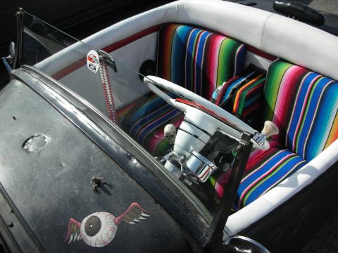 1998 Ford Crown Victoria - Open hot rod interior with colorful serape-covered seats, a chrome steering column and a winged-eyeball decal.