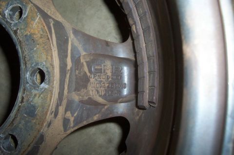 1994 Ford F-150 - A close-up view of a vehicle wheel and tire, showing manufacturer markings and some dirt accumulation.