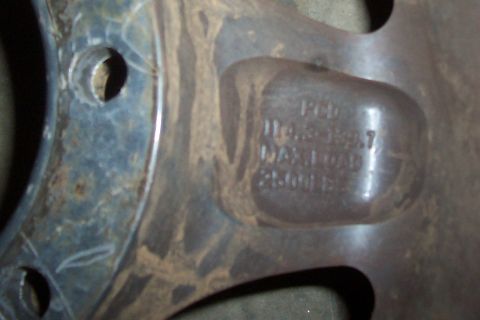 1994 Ford F-150 - A close-up view of a wheel rim shows stamped specifications, but no clear vehicle identification.