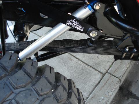 1994 Ford Bronco - Custom suspension component with 'Archie's OVERKILL' branding and a large off-road tire.