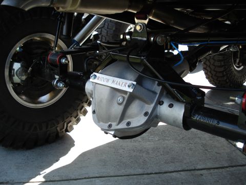 1994 Ford Bronco - The underside of a vehicle shows a modified rear differential with custom badging and suspension components.