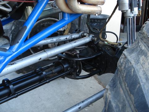 1994 Ford Bronco - Close-up view of the suspension and drivetrain of a heavily modified off-road vehicle.