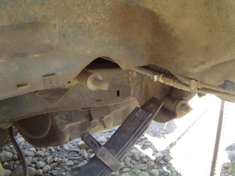 1967 Ford Bronco - Close-up view of a vehicle's undercarriage, revealing its frame and suspension components.