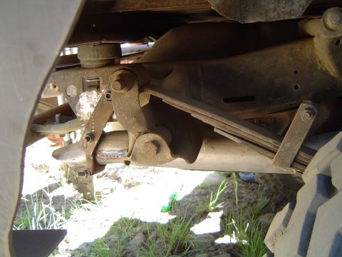 1967 Ford Bronco - Close-up of the undercarriage, focusing on the suspension system and exhaust components, with visible text from Supermotors.net.