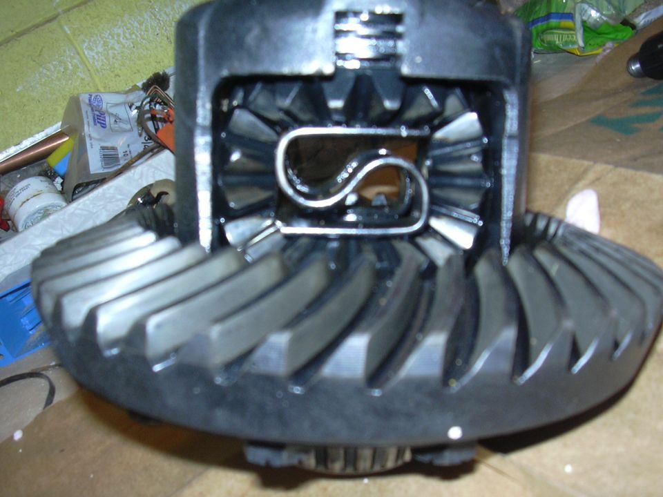 Differential gears with a metal C-clip inside, close-up view