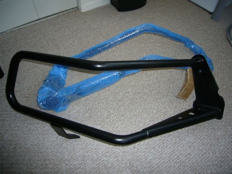 2000 Ford Crown Victoria - A black bull bar is shown on a carpeted surface, partially covered in protective blue bubble wrap.