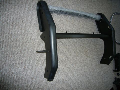 2000 Ford Crown Victoria - A black bull bar, possibly for a truck or SUV, is shown leaning against a carpeted surface.