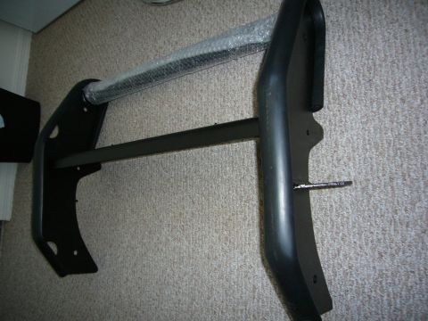 2000 Ford Crown Victoria - A black bull bar is shown from an angle, resting on a carpeted surface.