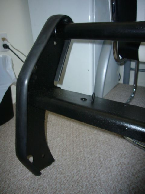 2000 Ford Crown Victoria - Close-up of a black bull bar, a vehicle accessory, shown indoors.