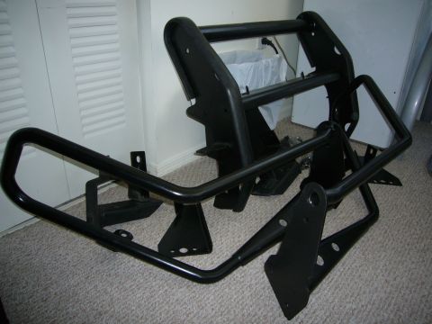 2000 Ford Crown Victoria - A black bull bar, likely for a police or utility vehicle, is shown disassembled on a carpeted floor.