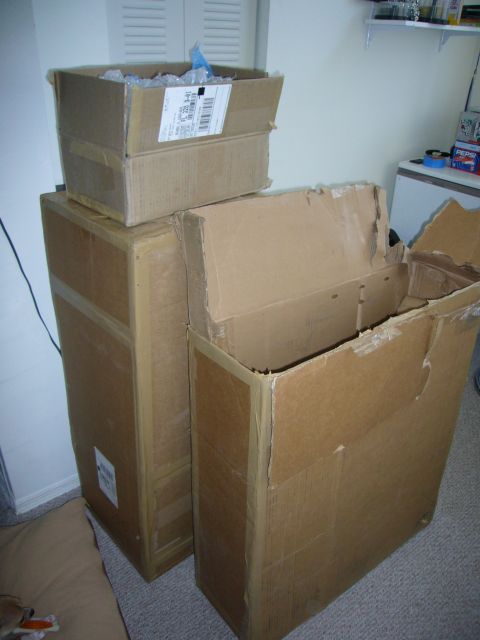 2000 Ford Crown Victoria - Several cardboard boxes are stacked in a room, one box has a shipping label on it.