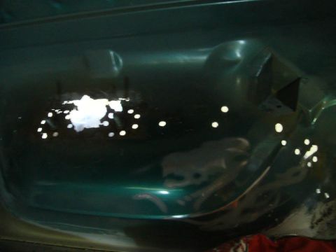 1996 Ford Bronco - Interior floor of a 1996 Ford Bronco undergoing rust repair with drilled holes.