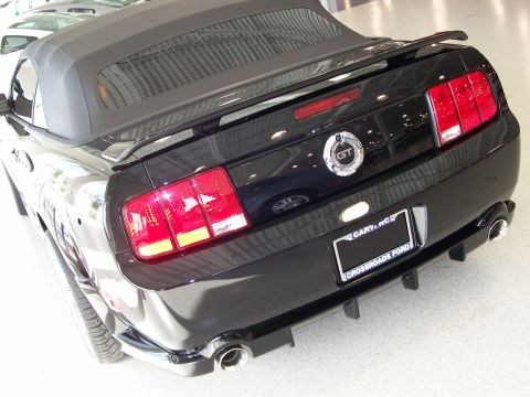 1996 Ford Bronco - Rear view of a black convertible sports car, identified as a GT model.