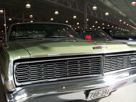 1996 Ford Bronco - Close-up of a vintage truck's front grille, a prominent chrome bumper and horizontal slats. The vehicle appears to be from the 1960s.