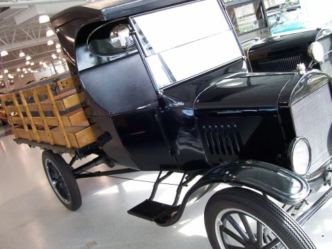 1996 Ford Bronco - This antique truck features a wooden bed and appears to be from the early 20th century.