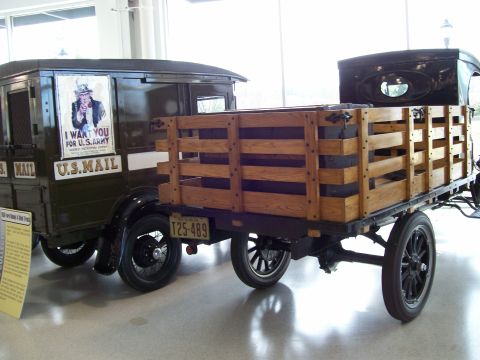 1996 Ford Bronco - A vintage U.S. Mail truck and a flatbed truck are displayed indoors, possibly at a museum.