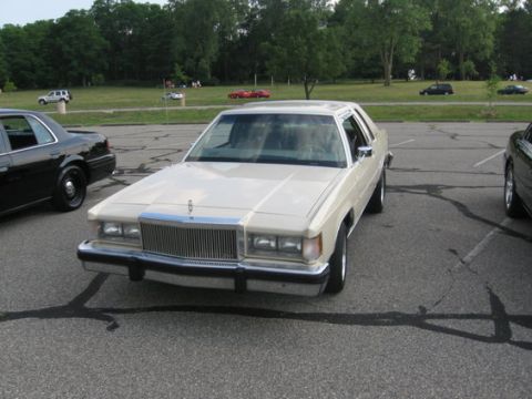 1988 Mercury Grand Marquis - Front view of a 1988 Mercury Grand Marquis parked in a lot with another car visible.