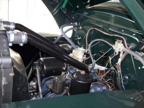 1996 Ford Bronco - Close-up view of a vehicle's engine bay, showing hoses, wiring, and engine components.