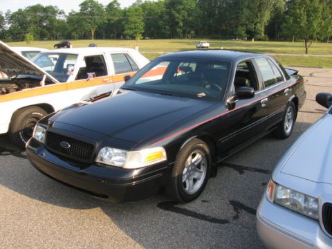 1988 Mercury Grand Marquis - Three sedans parked in an outdoor lot on a sunny day.