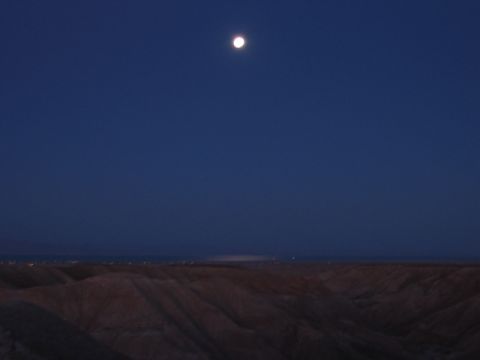 1997 Ford Ranger - The moon shines brightly in the dark blue sky over rolling desert hills.
