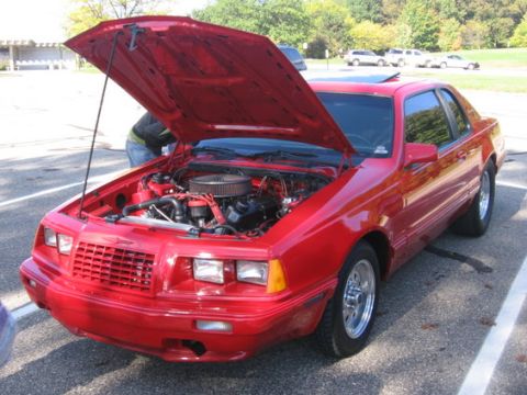 1988 Mercury Grand Marquis - Front view of a red 1987 Ford Thunderbird coupe with its hood raised to reveal the engine compartment.