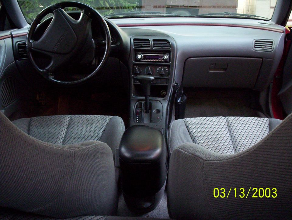 Interior of a 1993 Ford Probe, showing dashboard, steering wheel, seats, and center console
