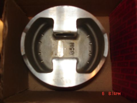 1994 Ford Probe - A close-up view of a piston, marked with '85M', is shown inside a cardboard box.