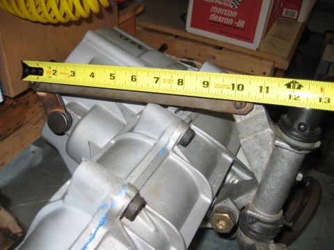 1992 Ford Bronco - A close-up view of a transmission component being measured with a tape measure.
