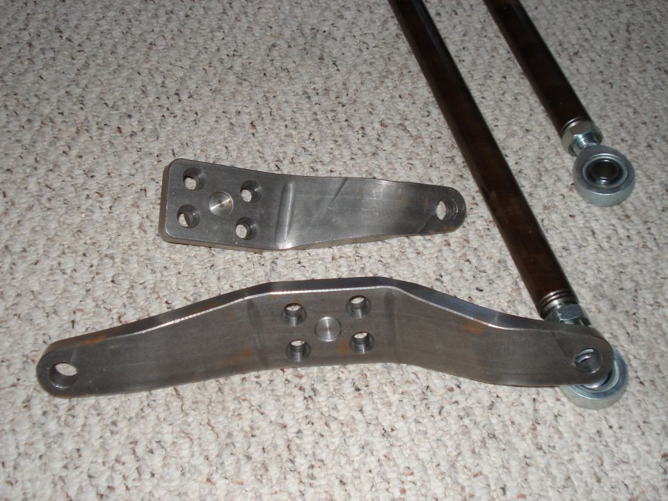 Two custom metal brackets and two dark metal rods with rod ends