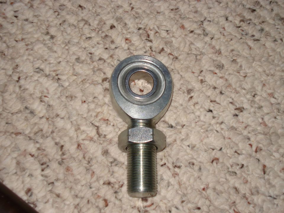 Rod end bearing with threaded stud and nut on carpet