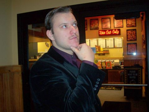 1988 Mercury Grand Marquis - A man ponders his next move while standing in front of a restaurant's takeout counter.