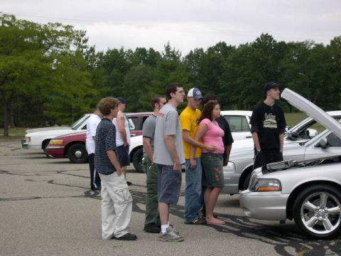 1988 Mercury Grand Marquis - People observing cars at an outdoor gathering, with multiple vehicles on display.