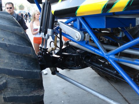 1994 Ford Bronco - Close-up view of a monster truck's suspension system and massive tire.