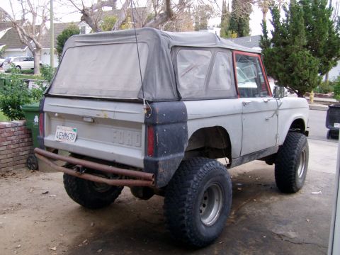 1967 Ford Bronco - This Ford Bronco, likely a 1966 model, is viewed from the rear with a soft top and lifted suspension.