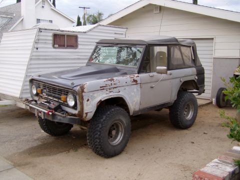 1967 Ford Bronco - 1967 Ford Bronco in primer, equipped with a winch and towing a trailer.