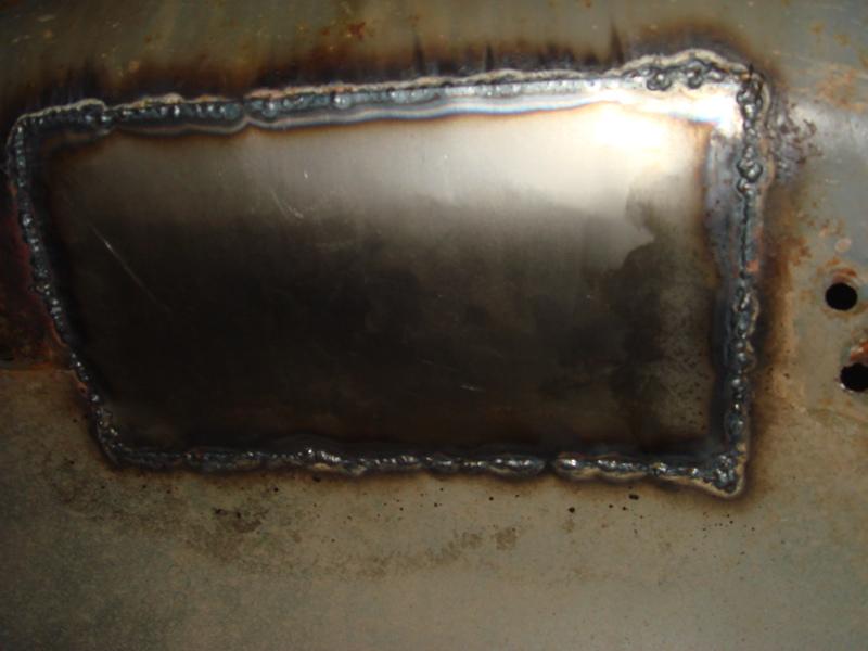 welded metal patch on rusty surface